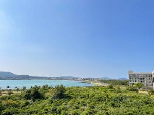 a view of a body of water from a hill at Ocean Star Resorts - Seopjikoji in Seogwipo
