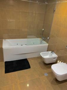 a bathroom with a bath tub and a toilet at Apartamento ALTAMIRA T2 SERRA SHOPPING in Covilhã