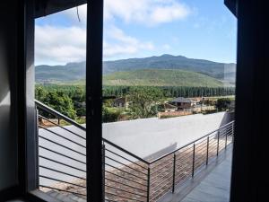 a view from a window of a balcony with mountains at Sou House in Louis Trichardt