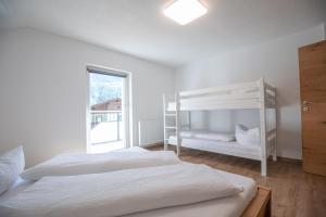 a bedroom with two bunk beds and a window at Apart Alp Line in Mils bei Imst