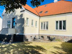 a white house with an orange roof at aday - Frederikshavn City Center - Charming double room in Frederikshavn
