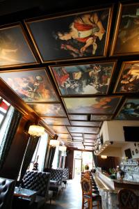 a room with paintings on the ceilings of a restaurant at Hotel Jelgava in Jelgava