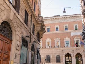 a group of buildings in a street in a city at The Best Rent - Bright apartment near Isola Tiberina in Rome
