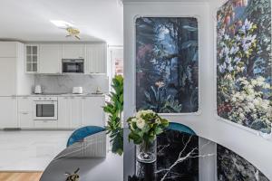 a kitchen with two large paintings on the wall at Bon Port 1-bedroom apartment – Lakefront in Territet
