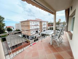 a balcony with a table and chairs on it at Sweet apartment in Calafell
