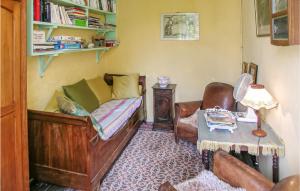 a bedroom with a bed and a chair and a table at Logis De Chenevière in Juignac