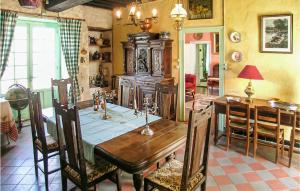 a dining room with a wooden table and a dining room at Logis De Chenevire in Juignac