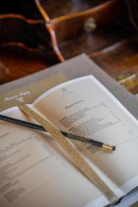 a pen sitting on top of a document on a table at Château Pape Clément in Pessac