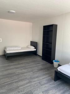 a room with two beds and a cabinet in it at Ferienzimmer Nr.20 in Bad Neuenahr-Ahrweiler