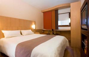 ibis Bulle - La Gruyère Swiss Bike Hotel客房内的一张或多张床位