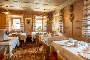 a dining room with tables and white tablecloths at Chalet Funtanacia in La Villa