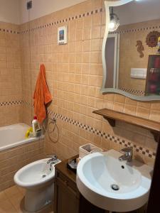 a bathroom with a sink and a toilet and a mirror at Taverna indipendente zona Ospedale Pescara in Pescara