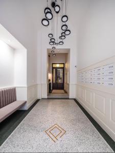 a hallway with a couch and a chandelier at Luxury apartment in the centre in Prague +20 photos