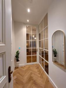 a hallway with a mirror and potted plants at Luxury apartment in the centre in Prague