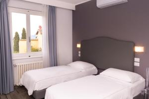 Postel nebo postele na pokoji v ubytování Hotel Villa Bonelli