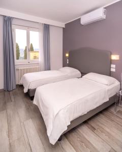 Postel nebo postele na pokoji v ubytování Hotel Villa Bonelli