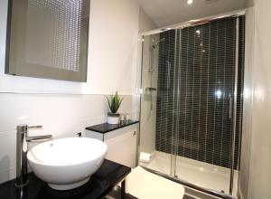 a bathroom with a toilet and a shower and a sink at Corbiere House @ Short Stays in Basingstoke