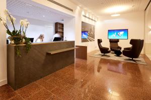 a lobby with a reception desk and chairs at Kasino Hotel in Leverkusen +33 photos