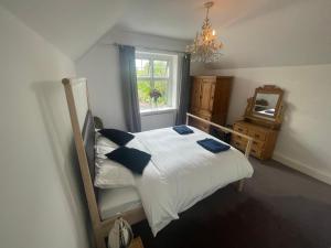 a bedroom with a bed and a mirror and a window at Lauderdale lodge barnstaple in Barnstaple