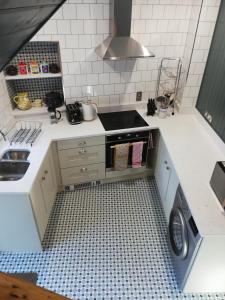 a small kitchen with a stove and a sink at Shoe Trader's Terrace in Rathmullan