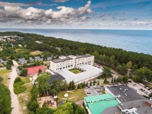an aerial view of a building next to the water at Hotel Astor in Jastrzębia Góra