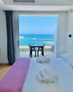 a bedroom with a bed with a view of the ocean at Boutique Lungomare in Porto Torres