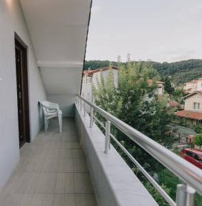 a balcony with a chair and a view of a city at Ağva Marina House in Istanbul