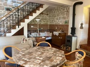 a living room with a table and chairs and a staircase at Be happy in Perast in Perast