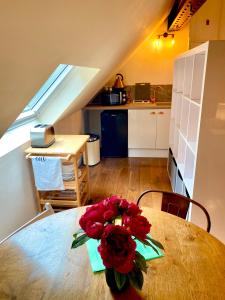 a table with a bouquet of red roses on it at Private Loft Country Hideaway in Shifnal +20 photos