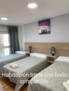 A bed or beds in a room at Pension Ameneiral