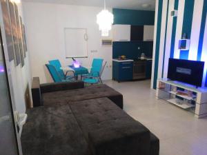 a living room with a couch and a table and chairs at Apartment Tara in Sumartin
