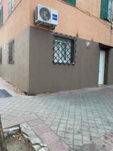 a building with a window with a fan on the side of it at Portalegre in Madrid