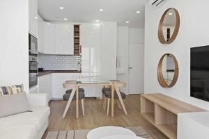 a living room with a white couch and a table at Timeless Sea II Apartment in Armação de Pêra
