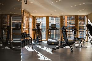 a gym with treadmills and cardio equipment in a building at Raffl's Tyrol Hotel in Sankt Anton am Arlberg