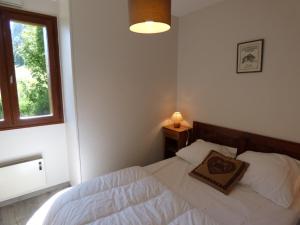 a bedroom with a bed with a pillow on it at Appartement Le Grand-Bornand, 2 pièces, 6 personnes - FR-1-458-108 in Le Grand-Bornand