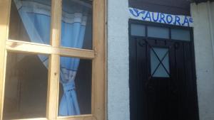 a window with a black door and a dress in a store at Cabaña Aurora in Zirahuén