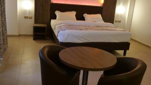 Un pat sau paturi într-o cameră la Hotel Franco Yaounde