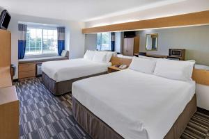 Voodi või voodid majutusasutuse Microtel Inn & Suites by Wyndham Plattsburgh toas