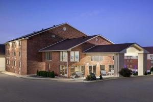 a large brick building with a lot of windows at AmericInn by Wyndham Branson & Conference Center in Branson