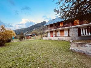 a house with solar panels on the side of it at La Baita Limone Riserva Bianca Ski-in Ski-out Seggiovia Morel 2 in Limone Piemonte