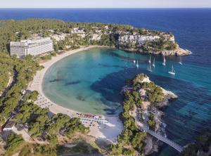 an aerial view of a beach with boats in the water at Villa Garbes in Cala Galdana