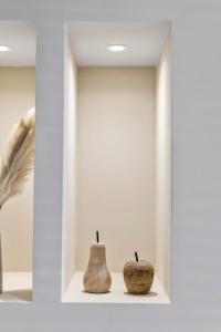 two vases sitting on a shelf in a room at The Burlington by STAMP SA in Blackpool