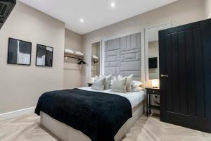 a bedroom with a large bed with white pillows at The Burlington by STAMP SA in Blackpool