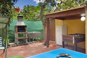 an outdoor kitchen with a stove and a sink at Casa Irene in Teror