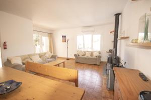 a living room with a couch and a table at Villa Garbes in Cala Galdana