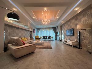 a living room with a couch and a dining room at Megafun Luxury Family Apartment in Baku