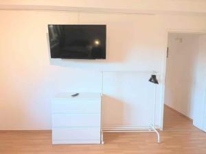 a living room with a tv on the wall at Holiday Apartments Brachttal in Hellstein