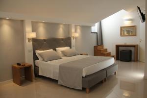 a bedroom with a large bed with white sheets and pillows at Hotel Nazionale in Levanto