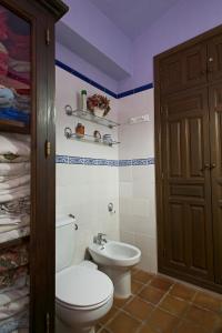 a bathroom with a toilet and a sink at Don Claudio in Grazalema