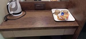 a table with a plate of food and a lamp at HOTEL PRATIKSHA RESIDENCY in Navi Mumbai